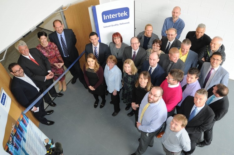 New Intertek site opens in UK: event attended by staff and a very tall photographer 