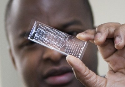 (Imagee: Jacqueline McBride/NEWSLINE Frederick Balagadde shows microfluidic device)